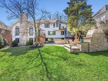 a view of a house with a yard and sitting area