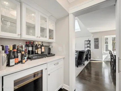 a kitchen with a refrigerator and wooden floor