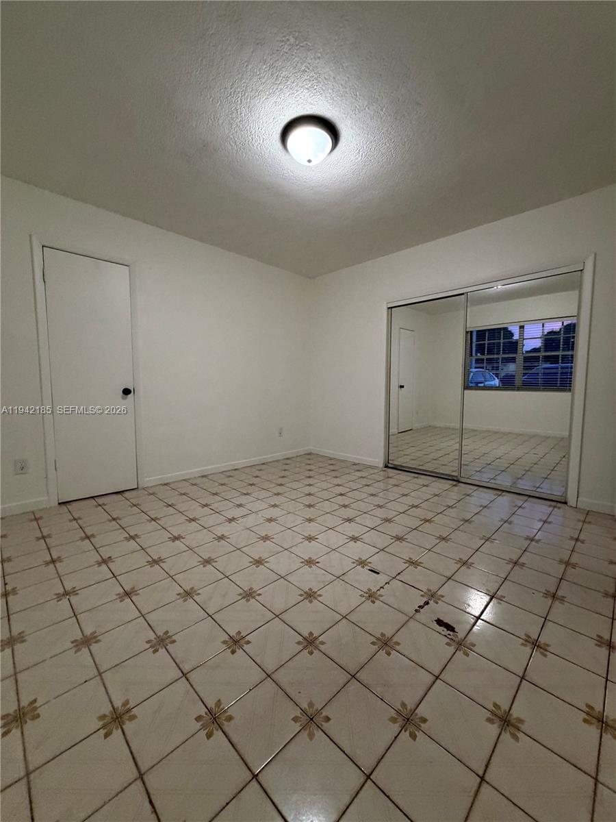 958 East 21st Street Hialeah, FL 33013 - Photo 14 of 16 a view of an empty room and wooden floor