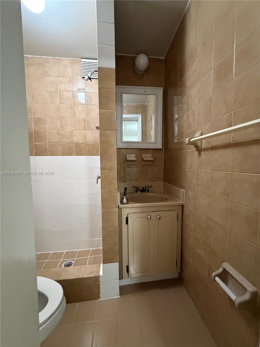 958 East 21st Street Hialeah, FL 33013 - Photo 15 of 16 a bathroom with a granite countertop sink a toilet and shower