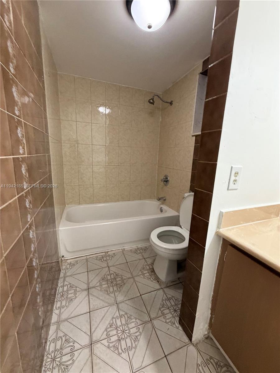 958 East 21st Street Hialeah, FL 33013 - Photo 16 of 16 a bathroom with a toilet a sink and a shower