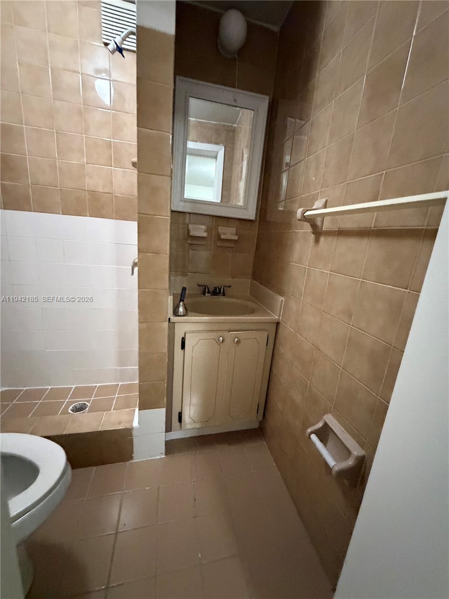 958 East 21st Street Hialeah, FL 33013 - Photo 7 of 16 a bathroom with a sink a toilet and shower