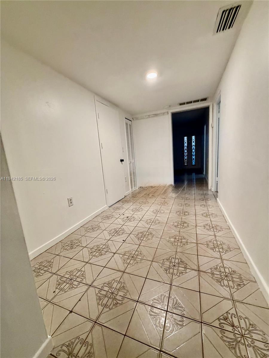 958 East 21st Street Hialeah, FL 33013 - Photo 8 of 16 a view of an empty room and kitchen