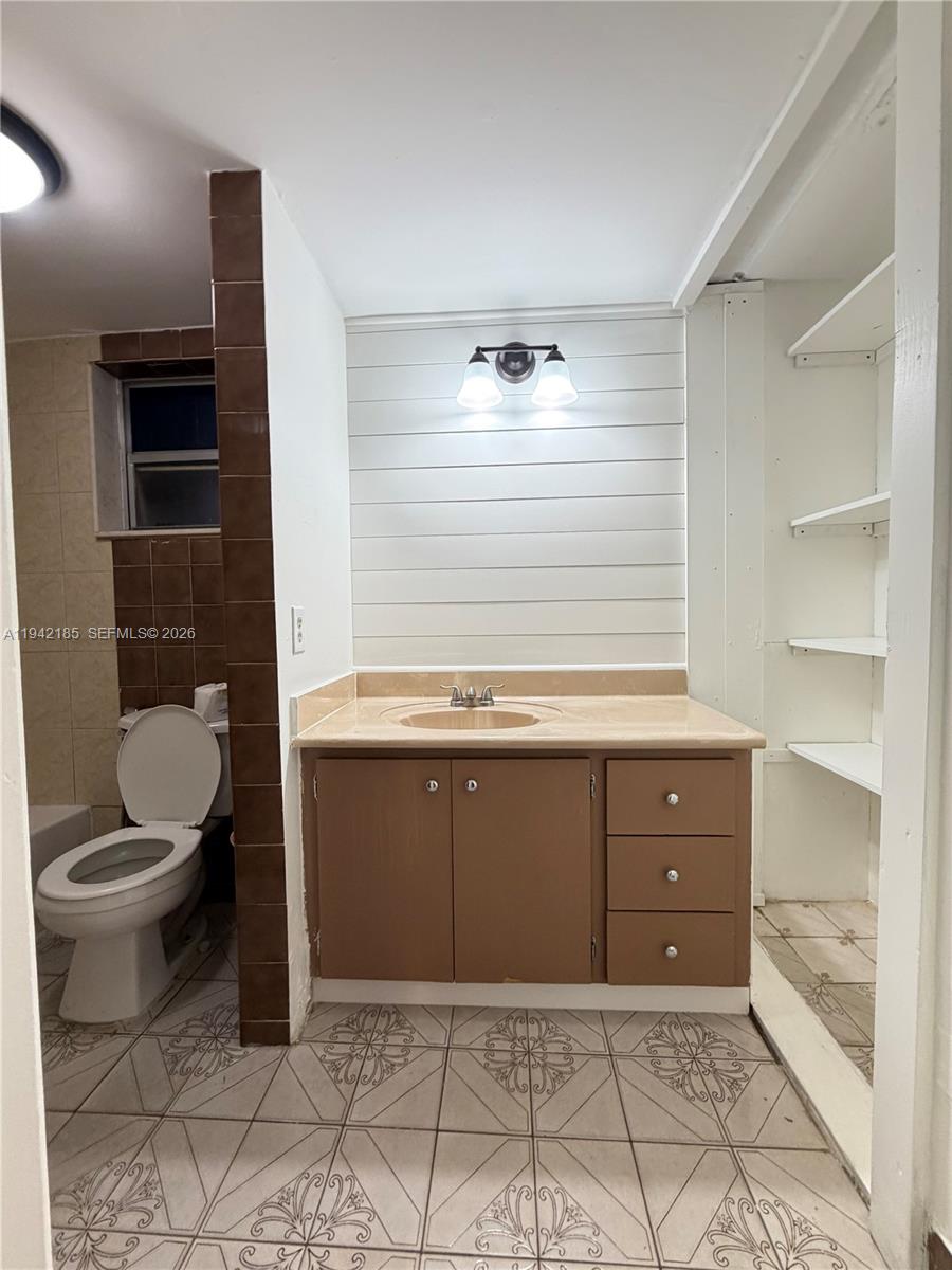 958 East 21st Street Hialeah, FL 33013 - Photo 9 of 16 a bathroom with a toilet sink and mirror