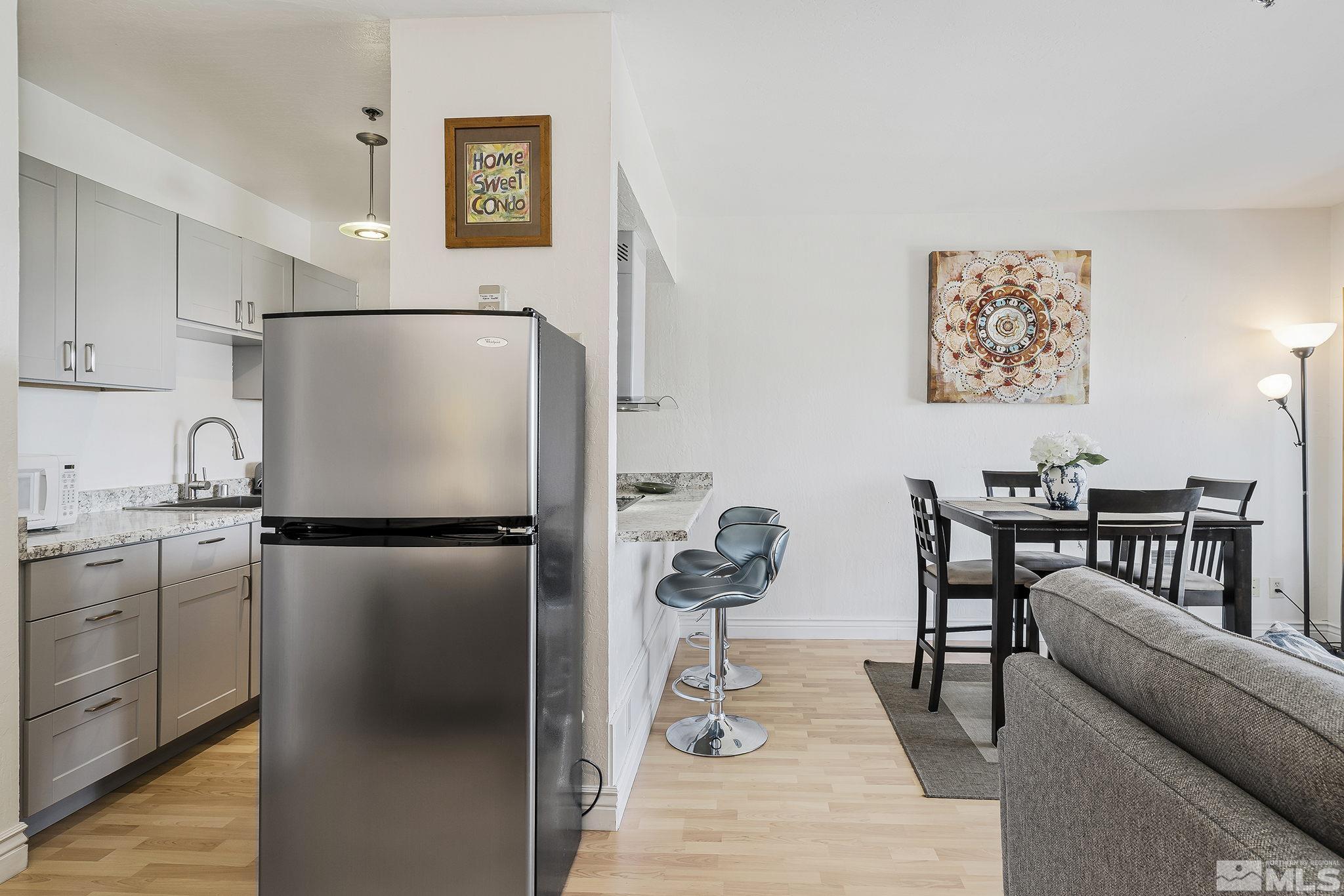 313 Tramway Drive, Unit 13 Stateline, NV 89449 - Photo 13 of 24 a kitchen with stainless steel appliances a refrigerator and a stove top oven