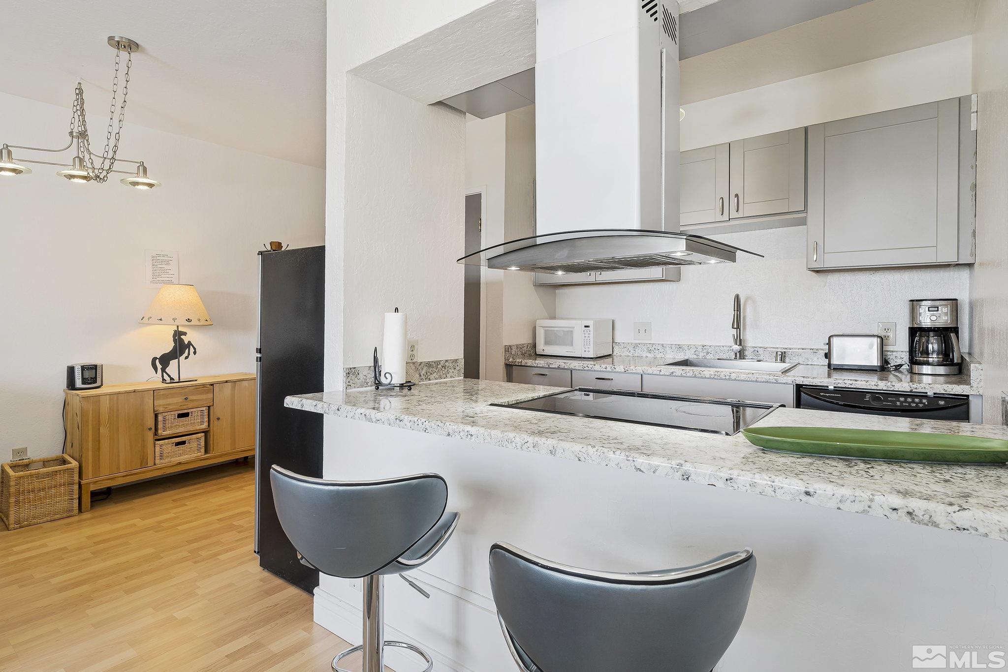 313 Tramway Drive, Unit 13 Stateline, NV 89449 - Photo 14 of 24 a kitchen with stainless steel appliances granite countertop a sink a stove and cabinets