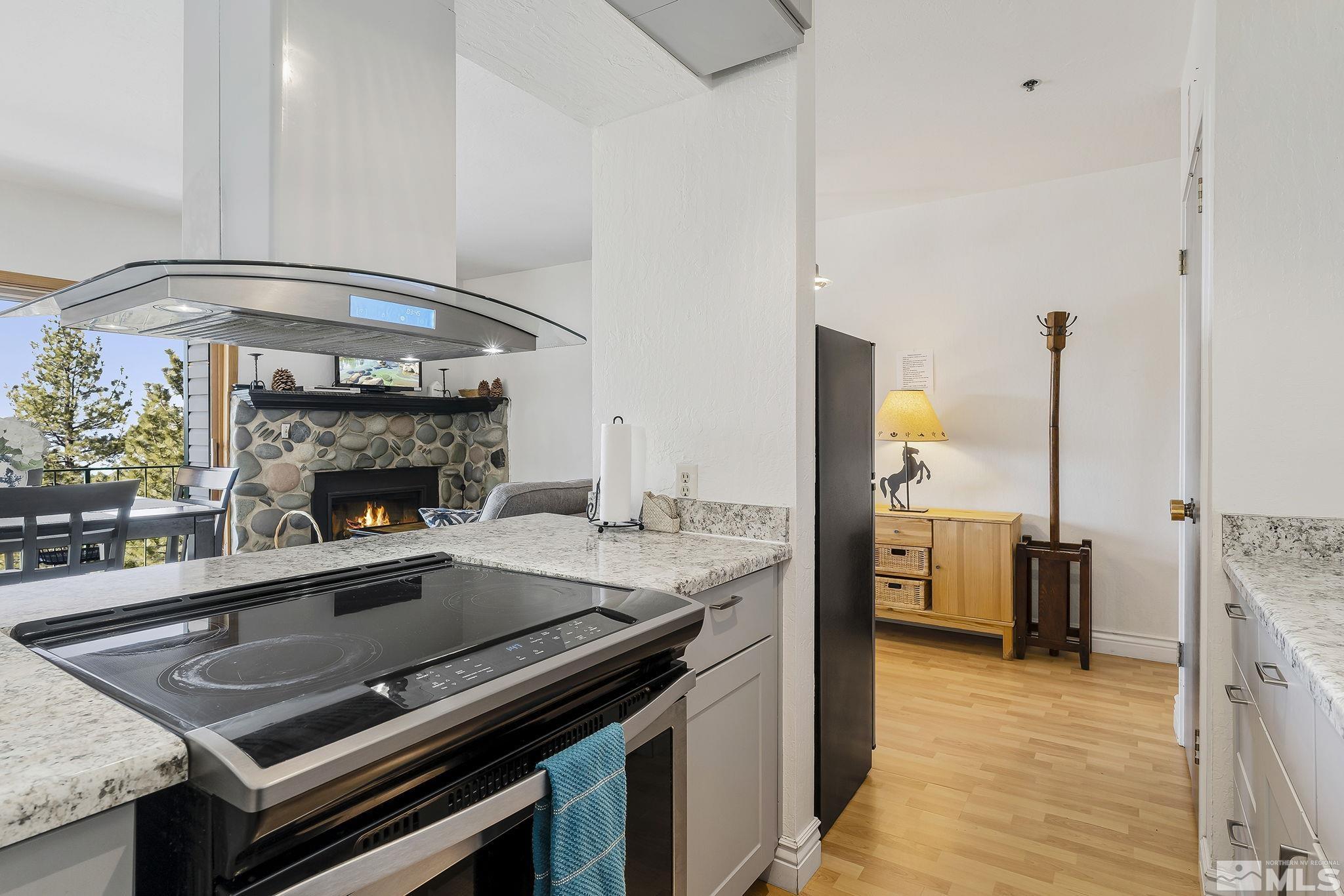 313 Tramway Drive, Unit 13 Stateline, NV 89449 - Photo 16 of 24 a open kitchen with a stove and a fireplace