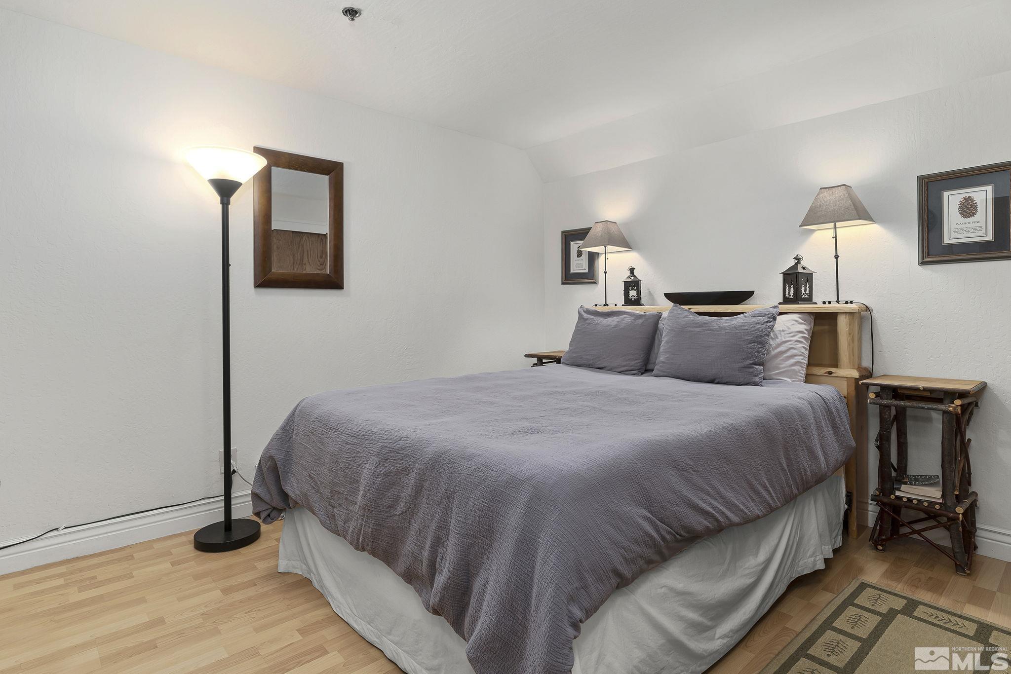 313 Tramway Drive, Unit 13 Stateline, NV 89449 - Photo 18 of 24 a bedroom with a bed and a night stand