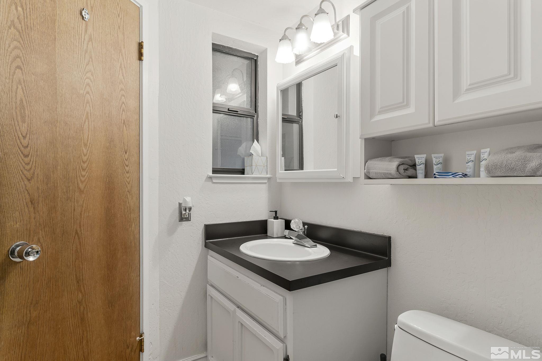 313 Tramway Drive, Unit 13 Stateline, NV 89449 - Photo 20 of 24 a bathroom with a sink and a mirror