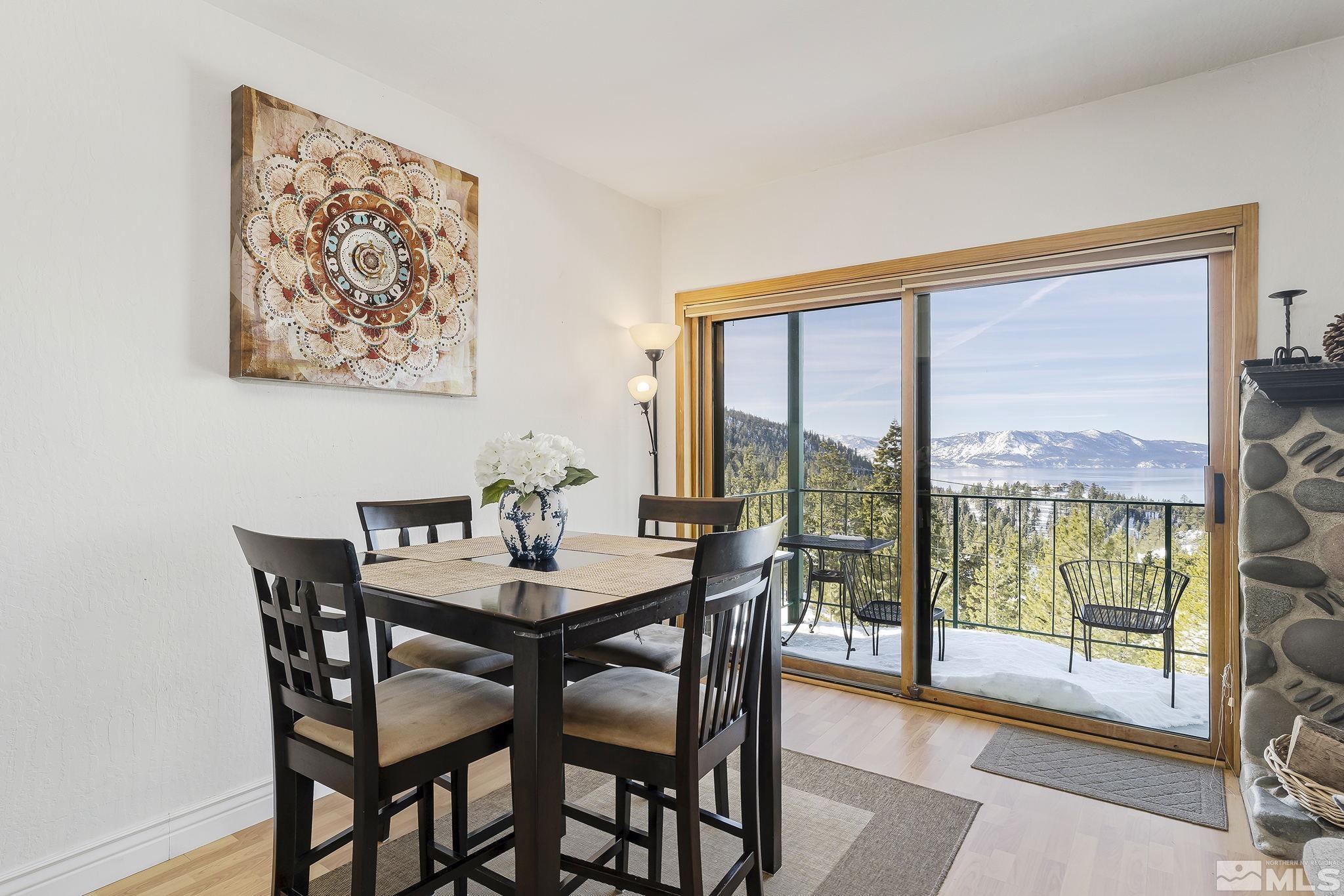 313 Tramway Drive, Unit 13 Stateline, NV 89449 - Photo 4 of 24 a view of a dining room with furniture large windows and wooden floor