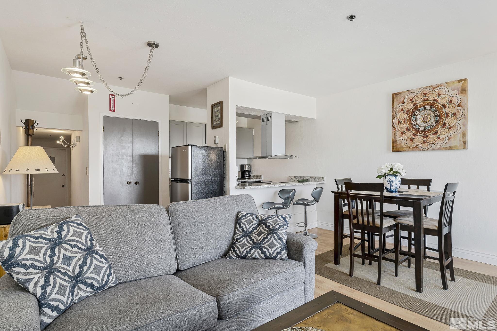 313 Tramway Drive, Unit 13 Stateline, NV 89449 - Photo 7 of 24 a living room with furniture a table and chairs