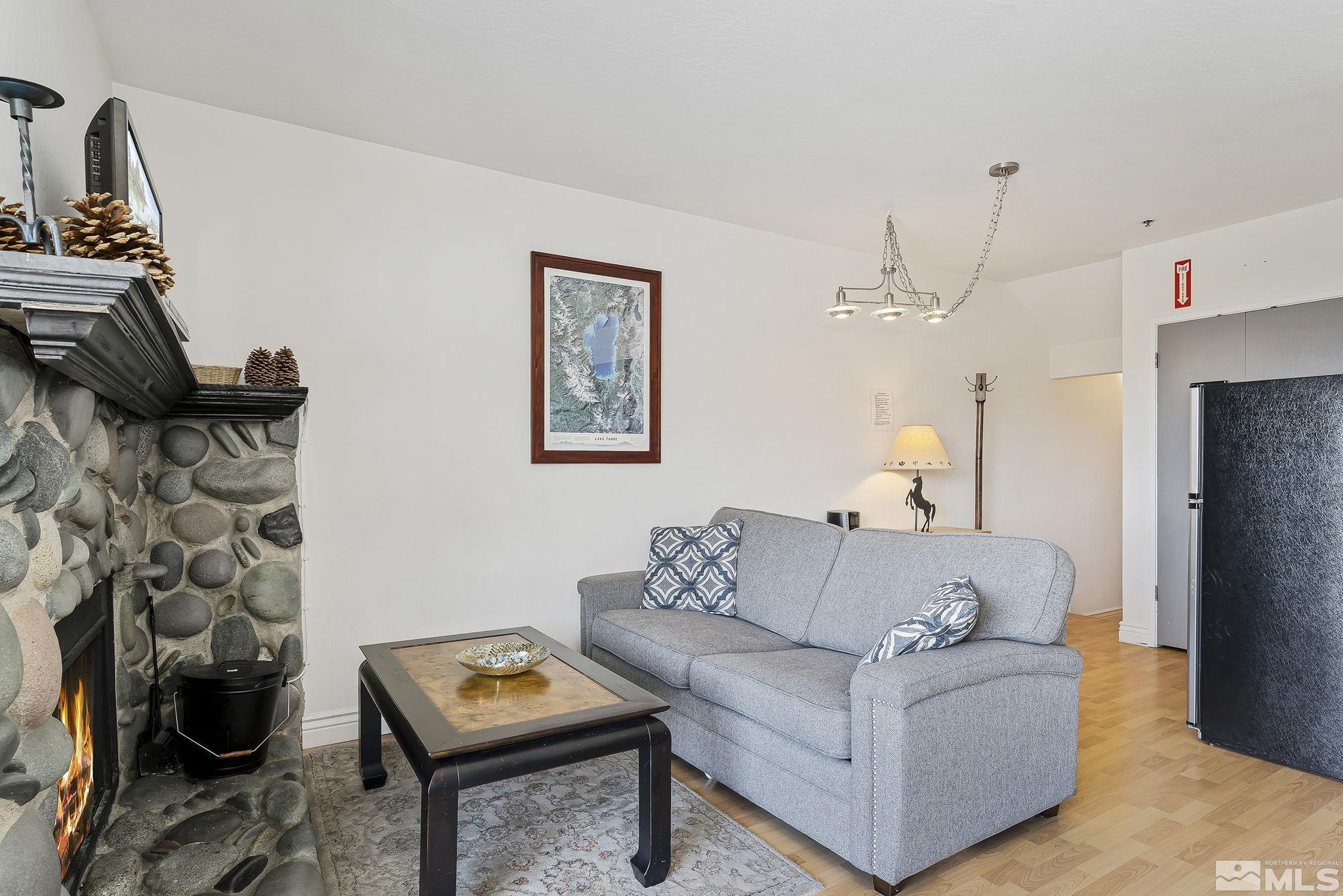 313 Tramway Drive, Unit 13 Stateline, NV 89449 - Photo 10 of 24 a living room with furniture and a wooden floor