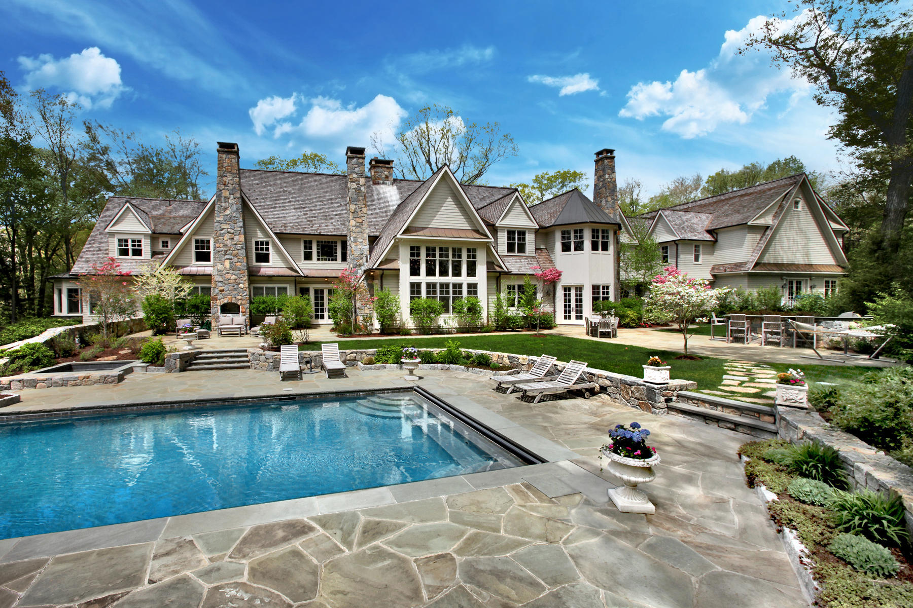 153 Chichester Road New Canaan, CT 06840 - Photo 1 of 32 a view of a house with swimming pool and sitting area