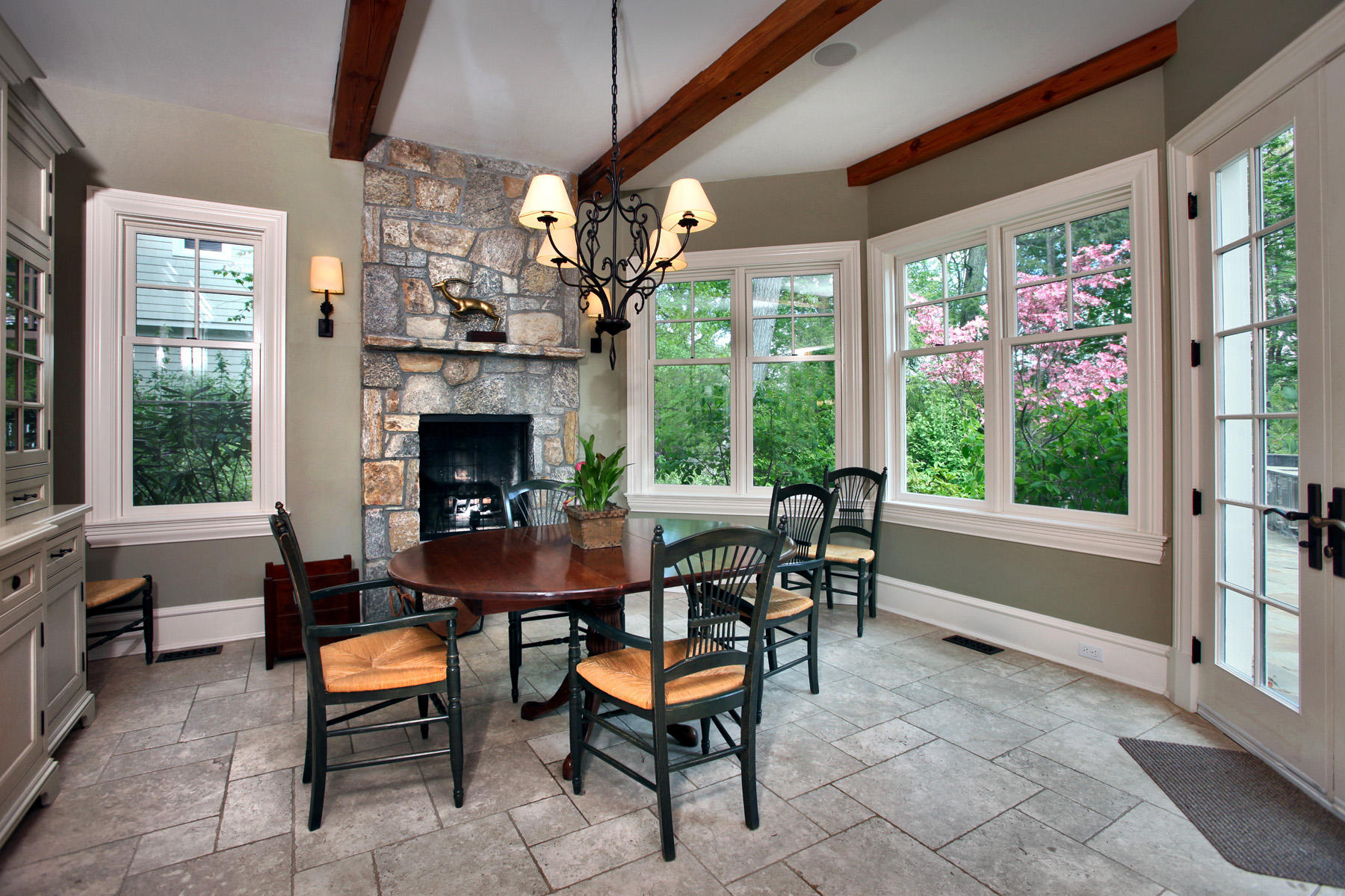 153 Chichester Road New Canaan, CT 06840 - Photo 11 of 32 a dining room with furniture a fireplace and large windows