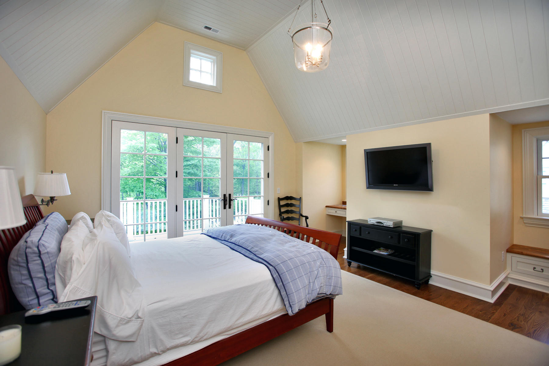 153 Chichester Road New Canaan, CT 06840 - Photo 20 of 32 a bedroom with a bed and a flat tv screen on dresser