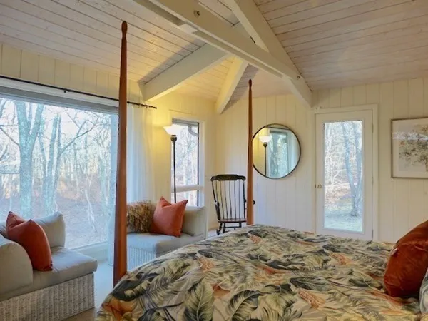 a bedroom with bed and a window