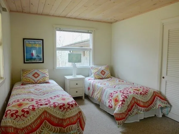 a bedroom with two beds and a window