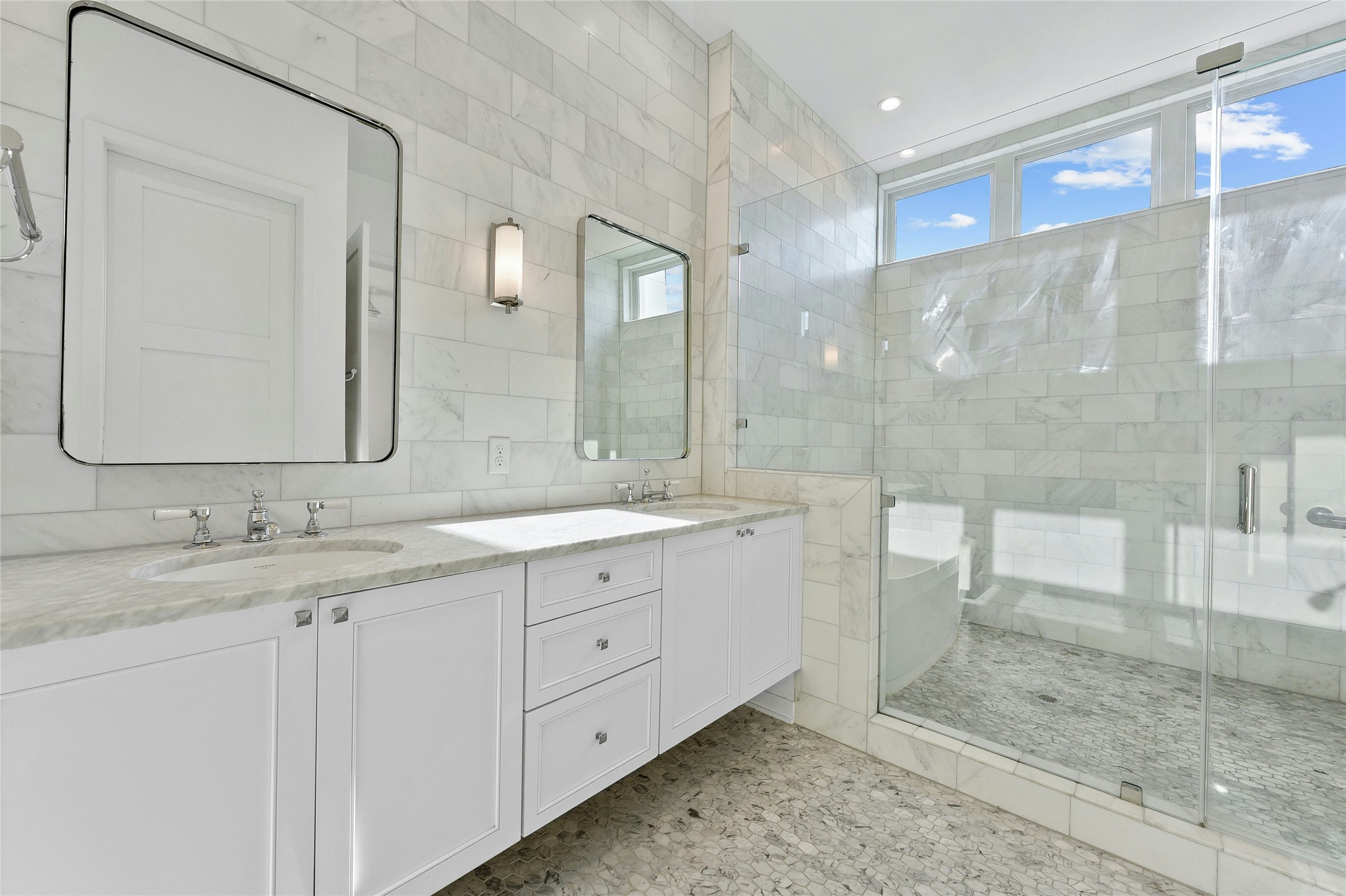 2518 Sutherland Street Austin, TX 78746 - Photo 16 of 30 Marble accents and a dual vanity elevate this primary bathroom's allure.