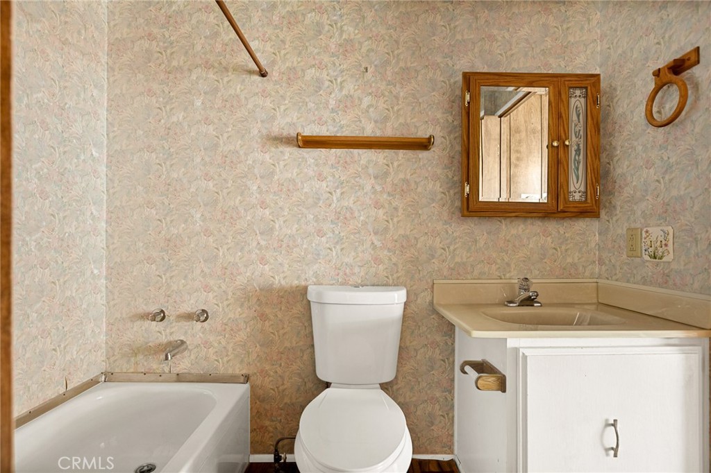 12367 4th Street Yucaipa, CA 92399 - Photo 15 of 19 a bathroom with a sink mirror bathtub and toilet