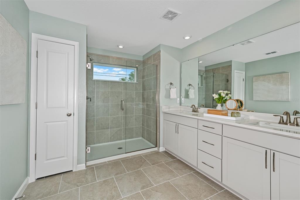 3358 Timber Xing Avenue Brandon, FL 33511 - Photo 16 of 22 a bathroom with a shower sink and mirror