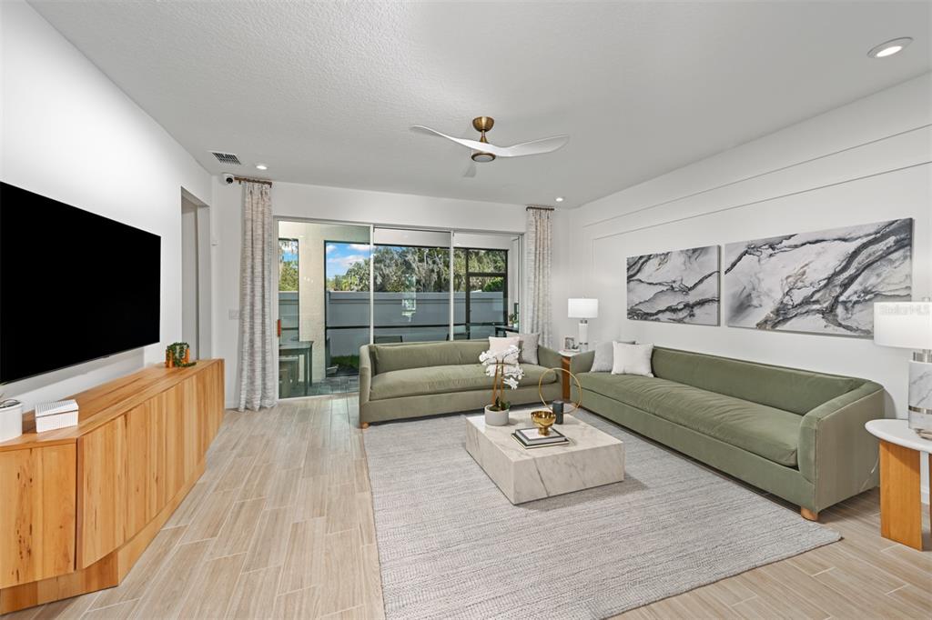 3358 Timber Xing Avenue Brandon, FL 33511 - Photo 10 of 22 a living room with furniture and a flat screen tv