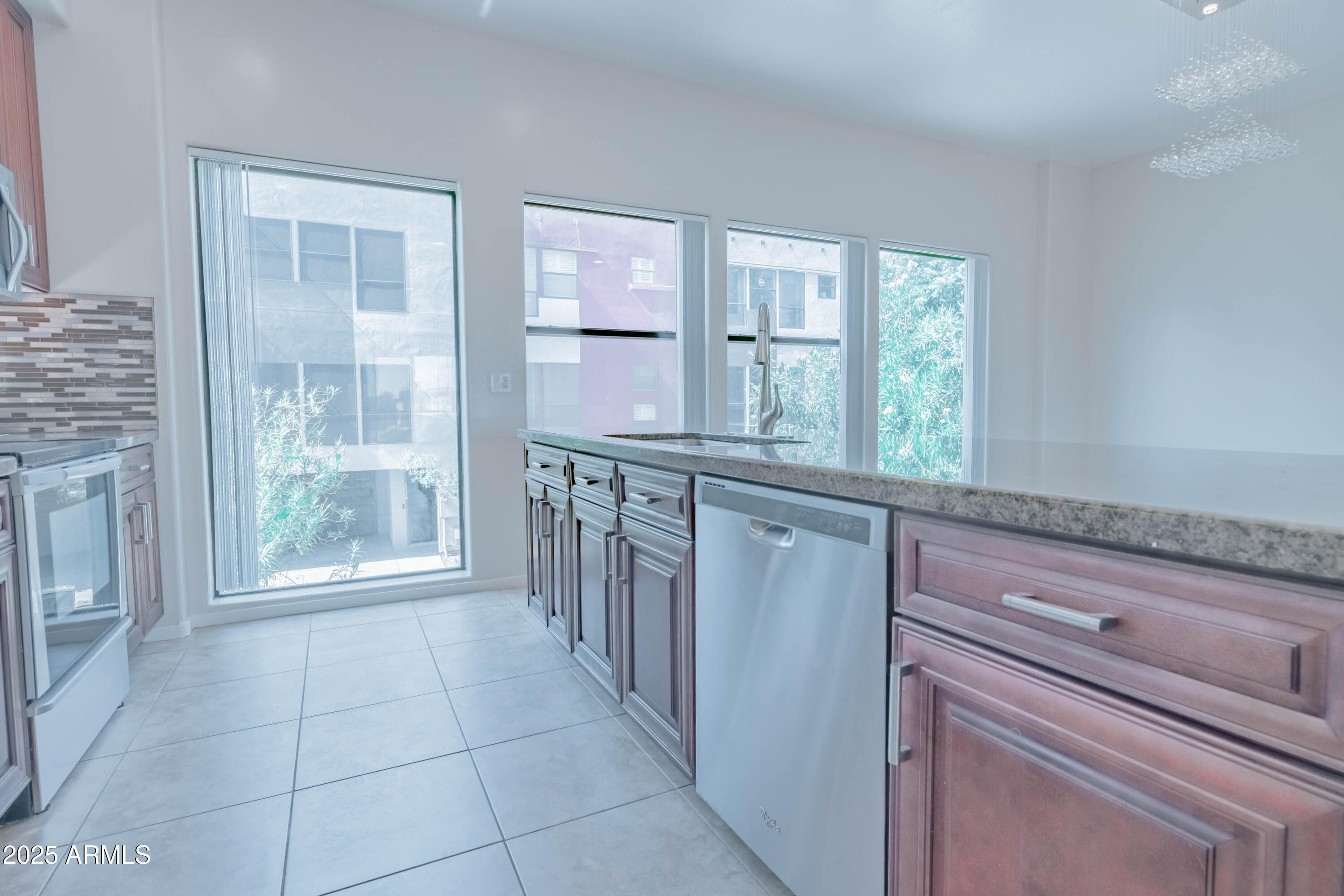 4739 East Culver Street Phoenix, AZ 85008 - Photo 13 of 55 a view of a kitchen with an empty room and windows