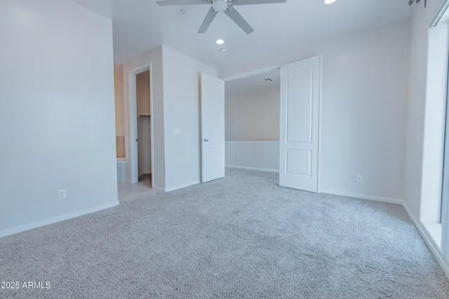 an empty room with windows and closet