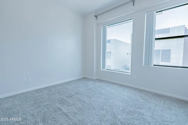 a bathroom with a granite countertop toilet sink and mirror