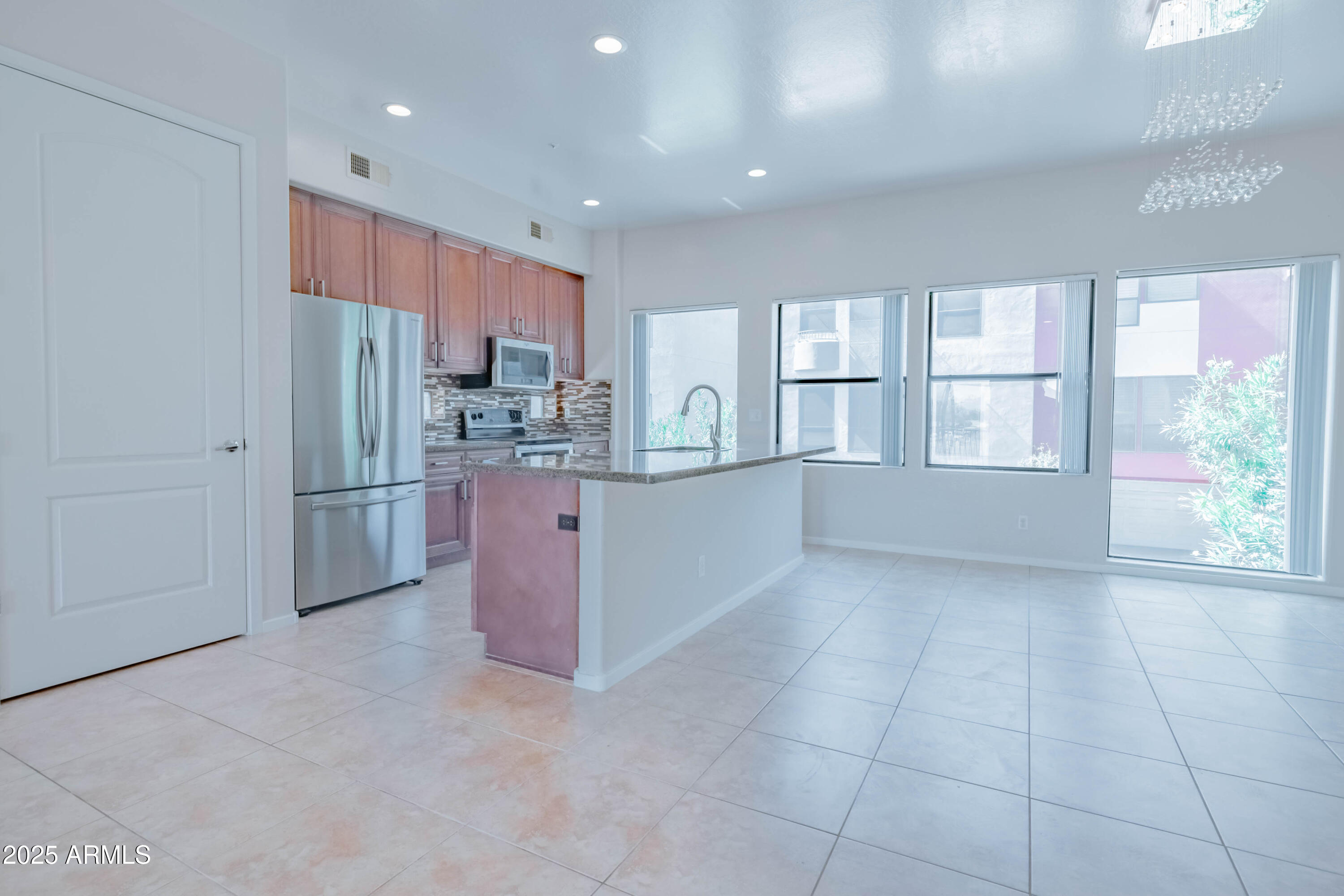 4739 East Culver Street Phoenix, AZ 85008 - Photo 10 of 55 a kitchen with stainless steel appliances a refrigerator and a stove top oven