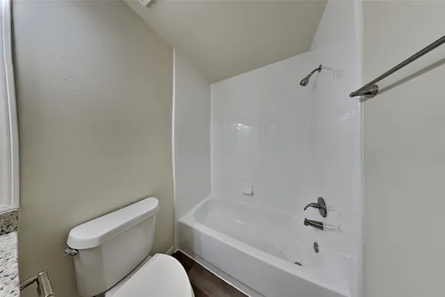 a bathroom with a bathtub and toilet