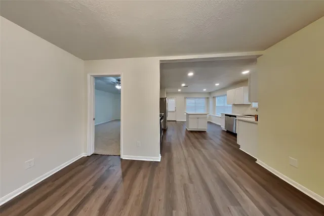 a view of a kitchen with wooden floor