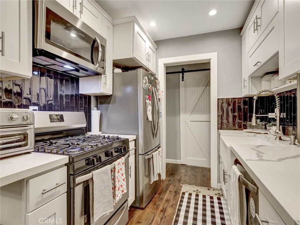 1200 West Lambert Road, Unit 44 La Habra, CA 90631 - Photo 15 of 33 a kitchen with stainless steel appliances granite countertop a stove and a refrigerator