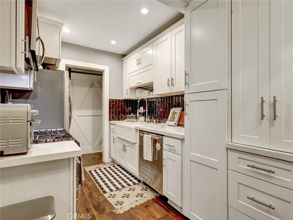 1200 West Lambert Road, Unit 44 La Habra, CA 90631 - Photo 16 of 33 a kitchen with white cabinets and white appliances