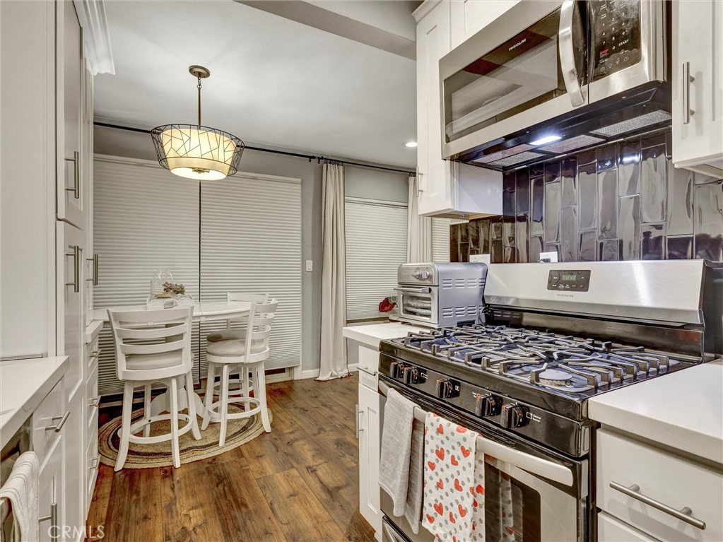 1200 West Lambert Road, Unit 44 La Habra, CA 90631 - Photo 17 of 33 a kitchen with a stove and a wooden floor
