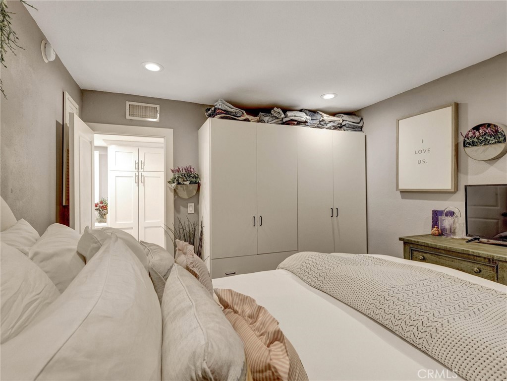 1200 West Lambert Road, Unit 44 La Habra, CA 90631 - Photo 7 of 33 a bedroom with a bed and a chandelier