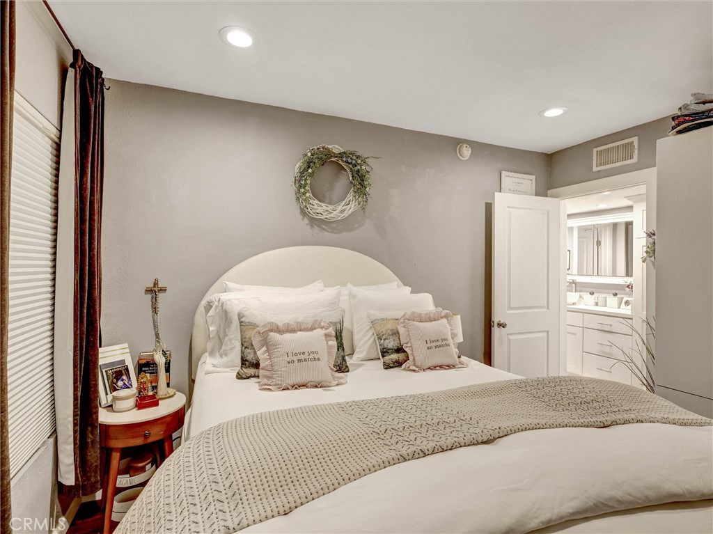1200 West Lambert Road, Unit 44 La Habra, CA 90631 - Photo 8 of 33 a bedroom with a bed and a chandelier