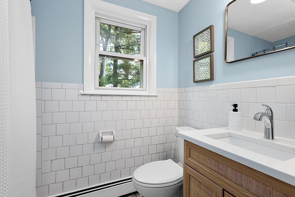 117 Oak Ridge Drive Ayer, MA 01432 - Photo 13 of 26 a bathroom with a sink a toilet and a window
