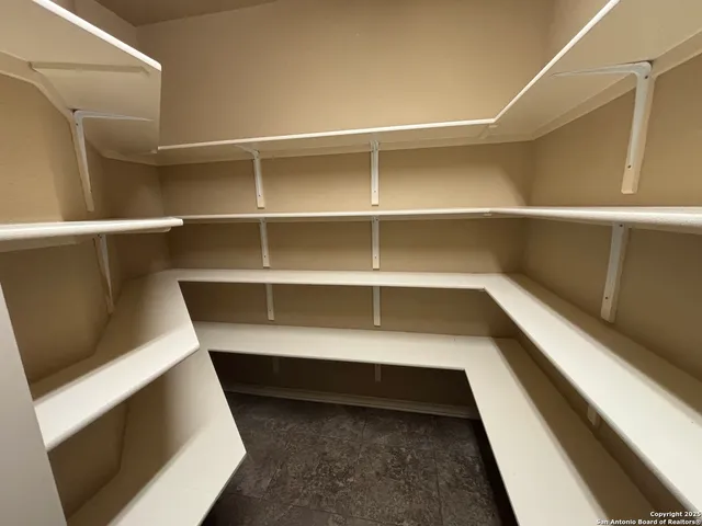 a bedroom with a bed and a lamp on table