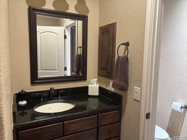 a room with walk in closet and wooden floor