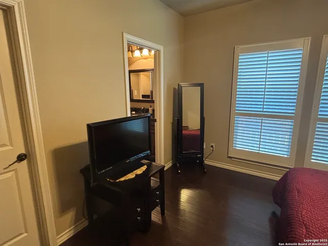 a bathroom with a granite countertop sink a mirror and a shower