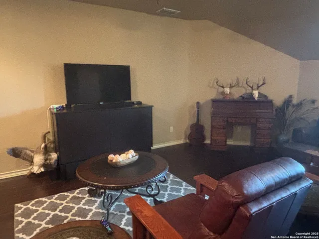 a view of a house with a patio and a yard