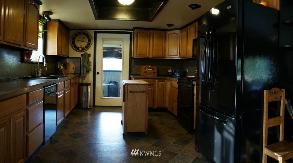 4435 Maytown Road Southwest Olympia, WA 98512 - Photo 2 of 25 a kitchen with stainless steel appliances granite countertop a refrigerator a stove top oven a sink and dishwasher