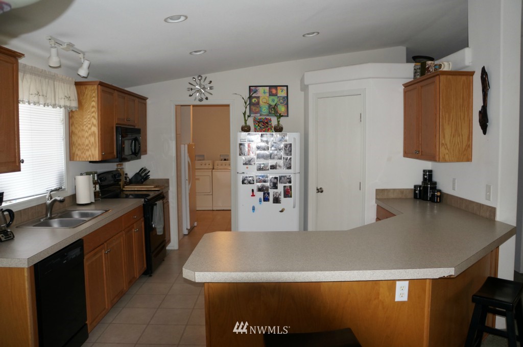 4435 Maytown Road Southwest Olympia, WA 98512 - Photo 13 of 25 a kitchen with a sink a stove and a refrigerator