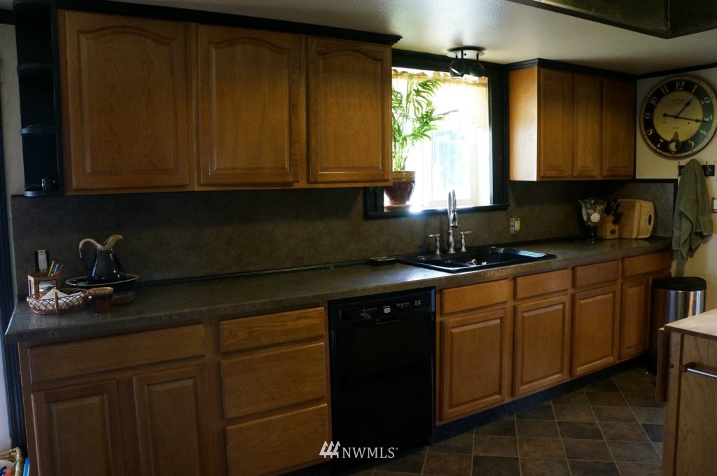 4435 Maytown Road Southwest Olympia, WA 98512 - Photo 3 of 25 a kitchen with a sink a stove cabinets and a window