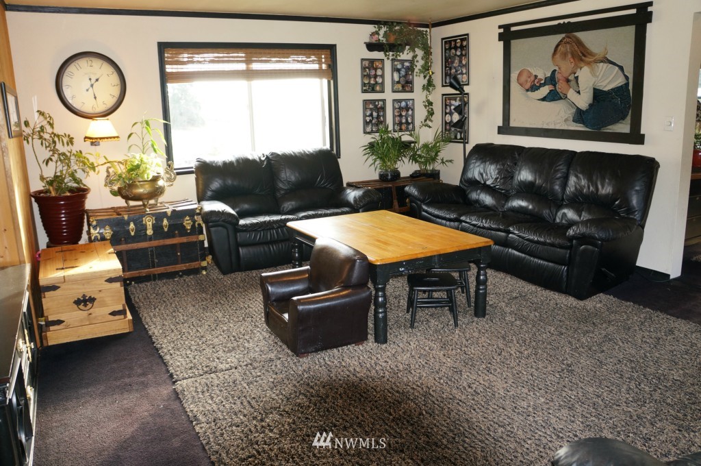 4435 Maytown Road Southwest Olympia, WA 98512 - Photo 9 of 25 a living room with furniture a clock and a large window
