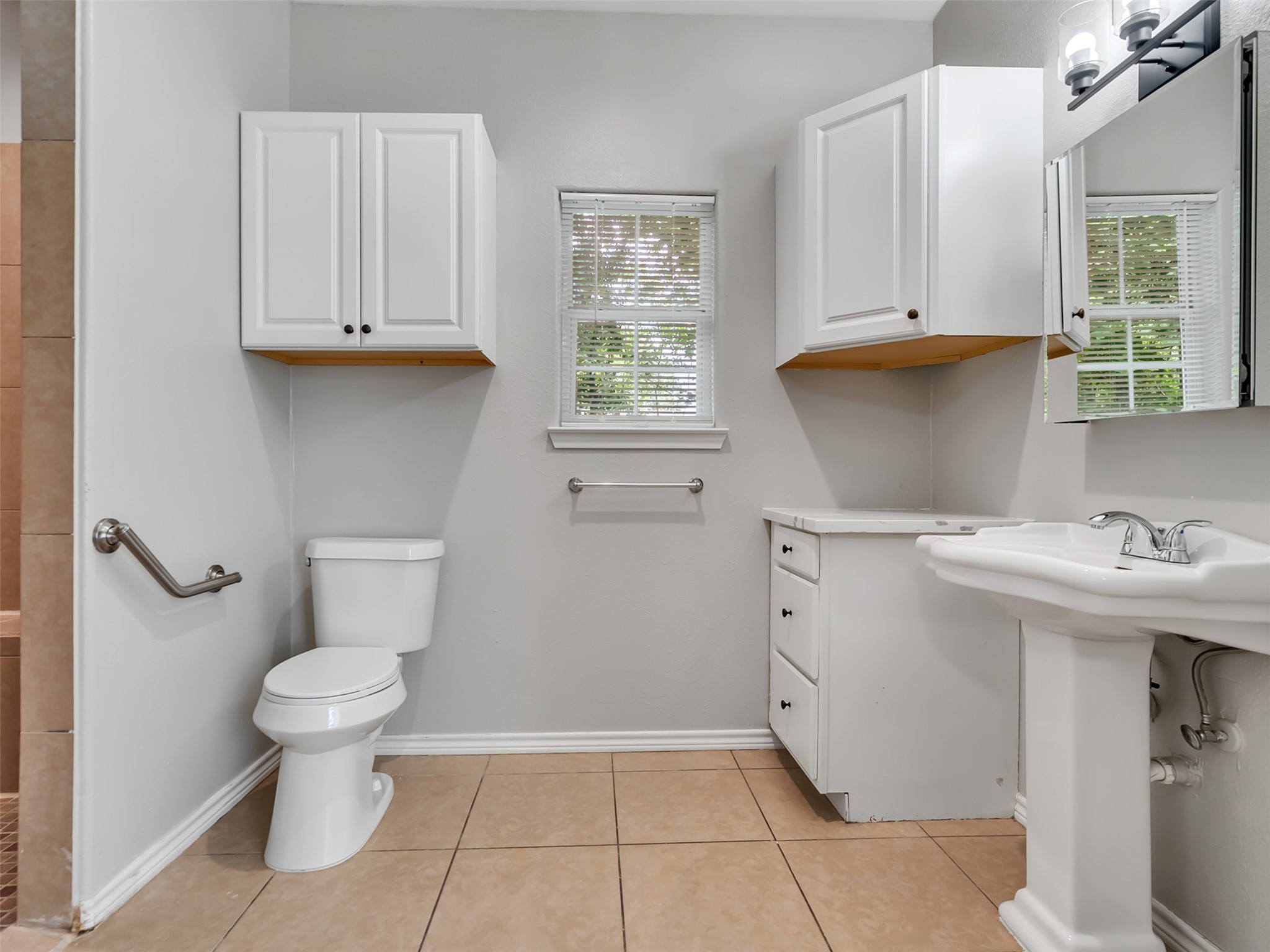 104 Longstreet Road, Unit 2 Willis, TX 77378 - Photo 21 of 26 a bathroom with a sink a toilet and a window