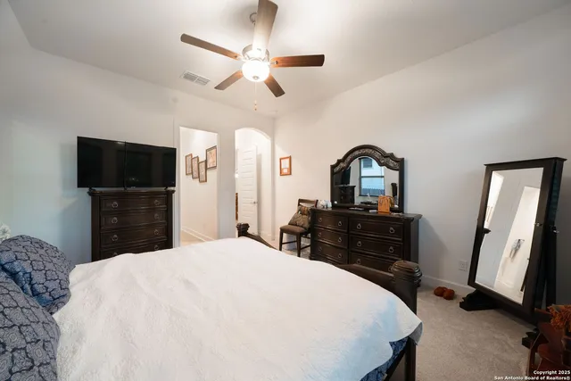 a bathroom with a granite countertop sink a mirror and a shower