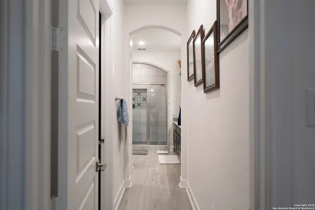a bathroom with a shower sink and mirror