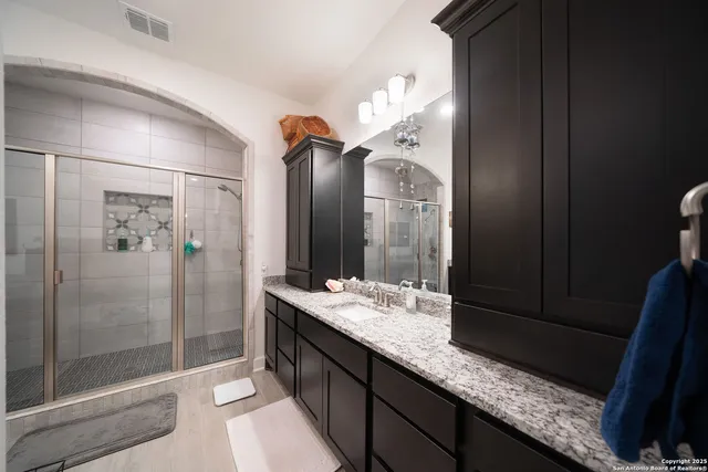 a bedroom with a bed and a flat tv screen on a dresser