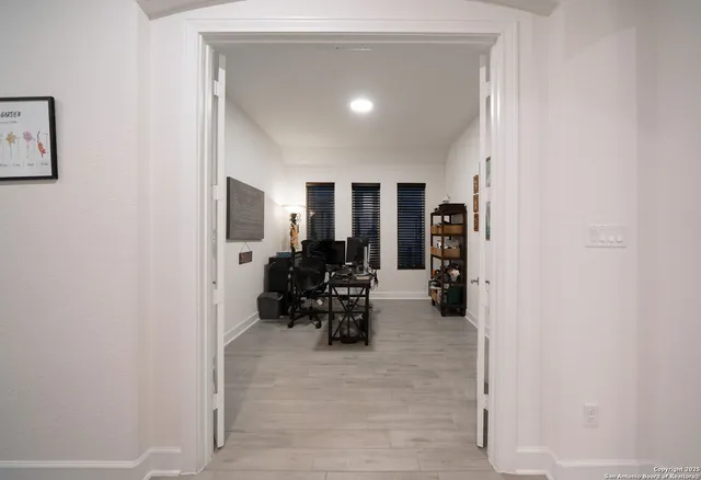 a view of a workspace with furniture and a window